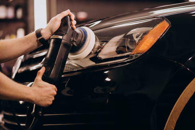 Professional polishing a red car taillight
